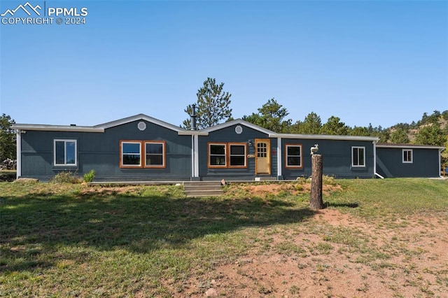 ranch-style home with a front lawn