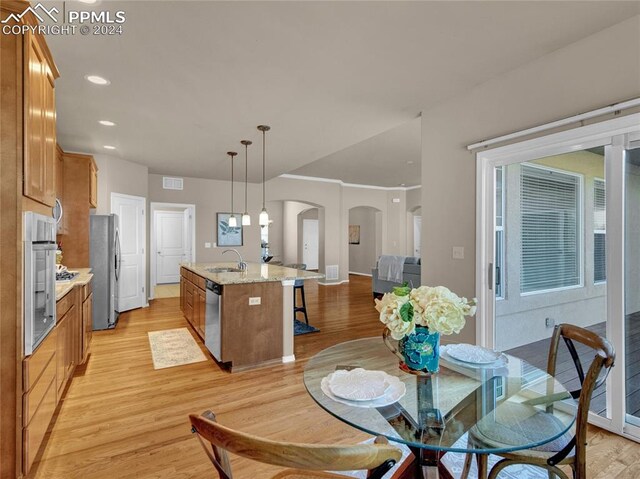 dining room featuring sink and light hardwood / wood-style floors