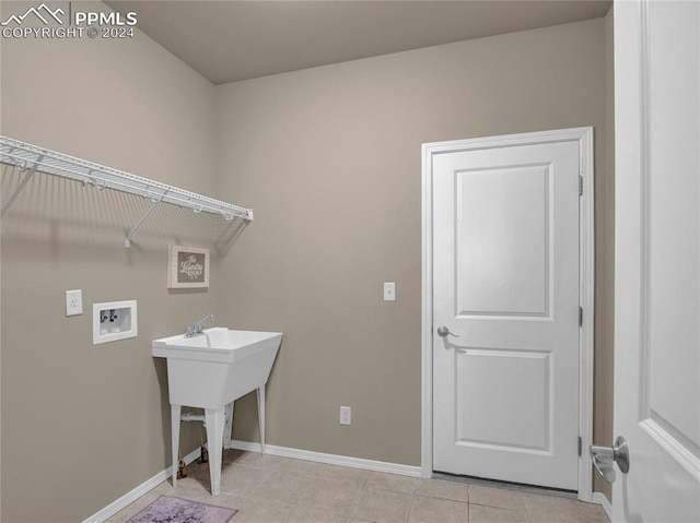 clothes washing area featuring hookup for a washing machine and light tile patterned floors