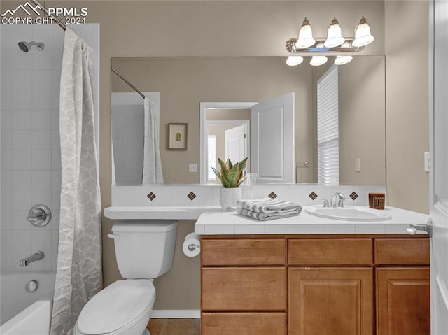 full bathroom featuring shower / bathtub combination with curtain, vanity, and toilet