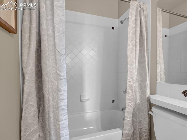 bathroom with toilet and shower / bathtub combination with curtain