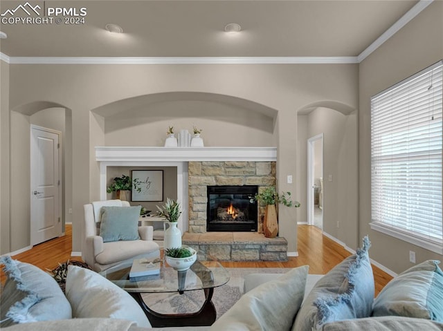 living room featuring hardwood / wood-style flooring, a fireplace, and ornamental molding