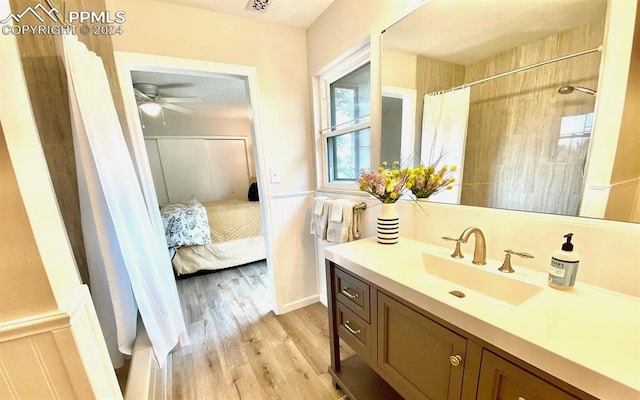 bathroom featuring ceiling fan, a shower with curtain, vanity, and hardwood / wood-style flooring