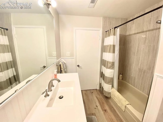 bathroom with vanity, shower / bath combination with curtain, and wood-type flooring