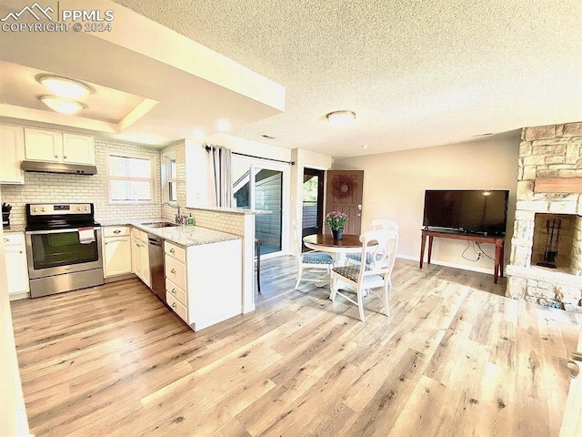 kitchen featuring appliances with stainless steel finishes, light hardwood / wood-style flooring, sink, and white cabinets