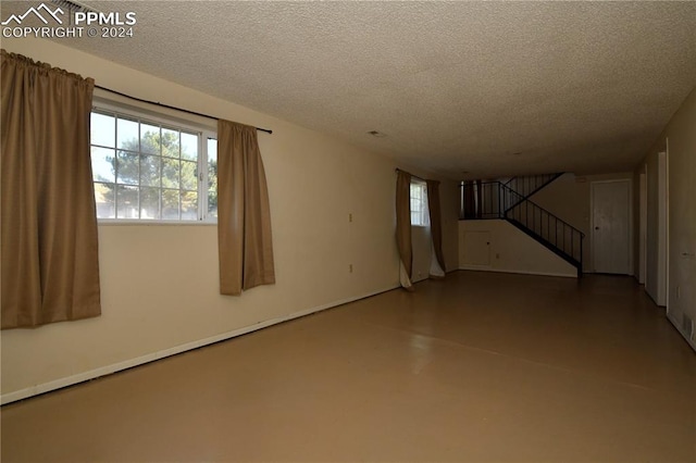 unfurnished room featuring concrete flooring and a textured ceiling