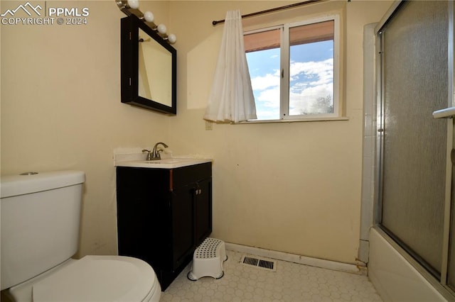 full bathroom featuring bath / shower combo with glass door, vanity, and toilet