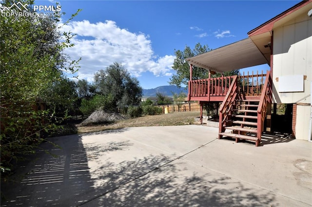 view of patio / terrace featuring a deck with mountain view