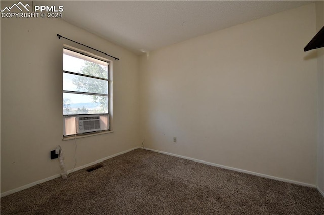 spare room featuring cooling unit and carpet floors