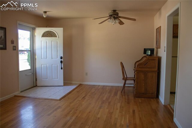 foyer entrance featuring ceiling fan and light wood-type flooring