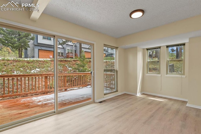 doorway with hardwood / wood-style flooring and a textured ceiling