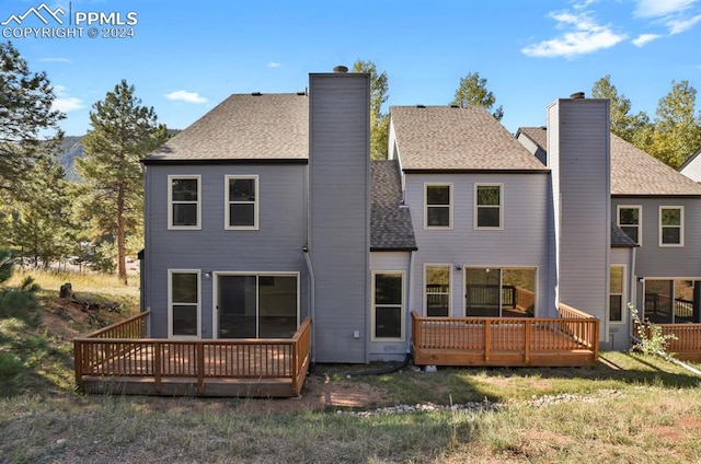 rear view of house with a wooden deck