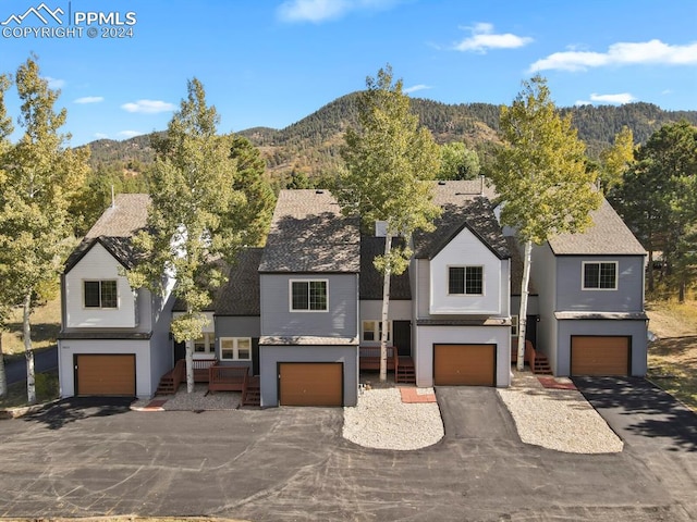 view of front facade featuring a garage and a mountain view