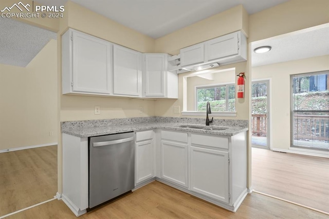 kitchen featuring white cabinets, dishwasher, sink, and a healthy amount of sunlight