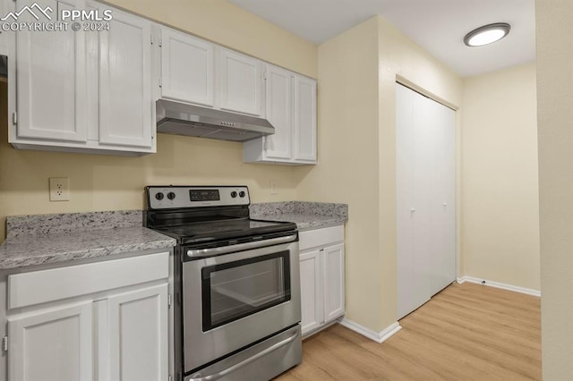 kitchen featuring white cabinets, light wood-type flooring, and stainless steel electric range oven