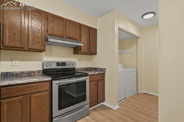 kitchen featuring light hardwood / wood-style floors, independent washer and dryer, and stainless steel electric range