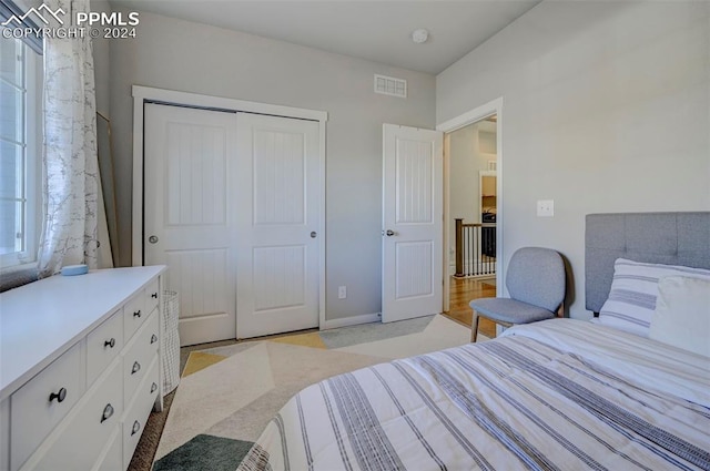 bedroom featuring a closet and light colored carpet