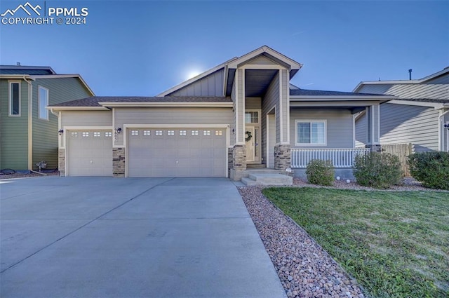 craftsman house with a garage and a front yard