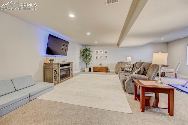 living room featuring carpet flooring and a fireplace