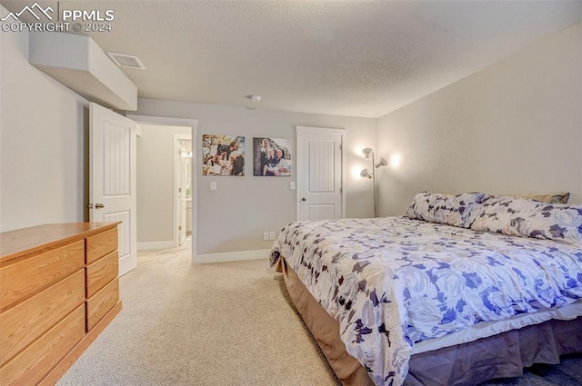 carpeted bedroom with a textured ceiling