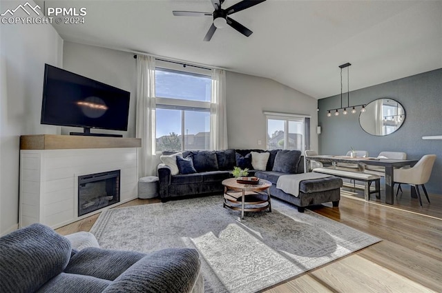 living room with vaulted ceiling, ceiling fan, and hardwood / wood-style flooring