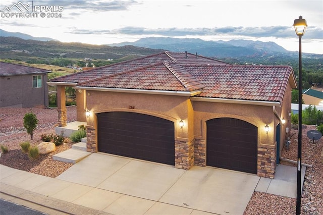 view of front of home featuring a mountain view and a garage