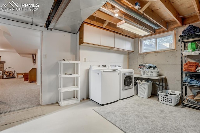 laundry area featuring washer and dryer and cabinets