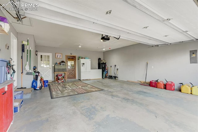 garage featuring a garage door opener, white fridge with ice dispenser, and electric panel