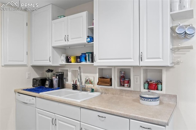 kitchen with dishwasher, sink, and white cabinetry