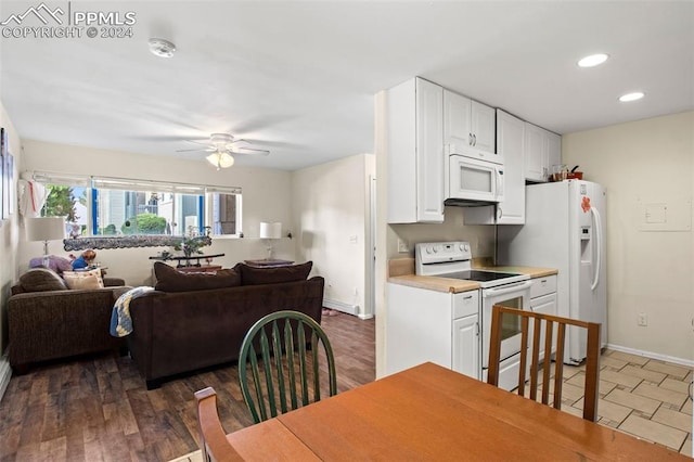 kitchen featuring white appliances, ceiling fan, white cabinetry, and dark wood-type flooring