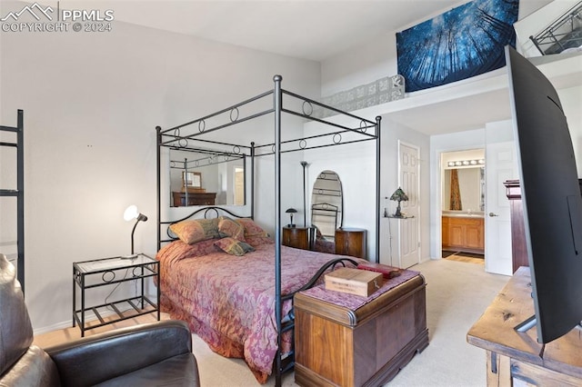 bedroom with connected bathroom and light colored carpet