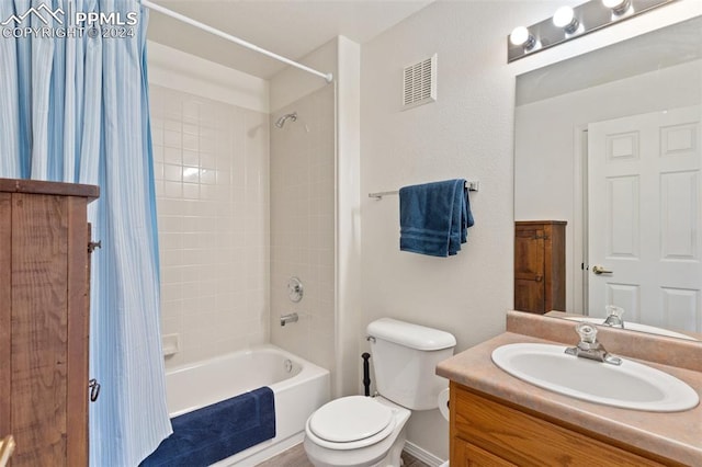 full bathroom with shower / bath combo, vanity, and toilet