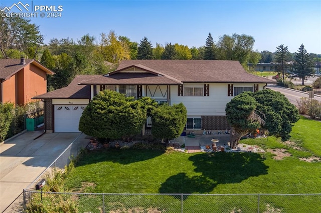 view of front of property featuring a garage and a front yard