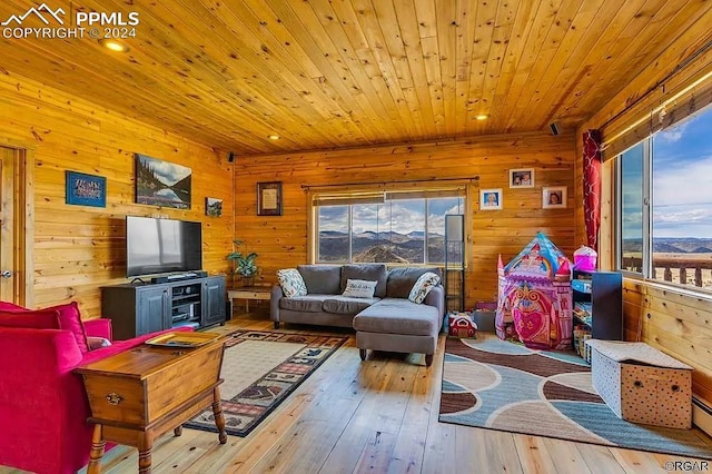 living room featuring wooden walls, light wood-type flooring, and wooden ceiling