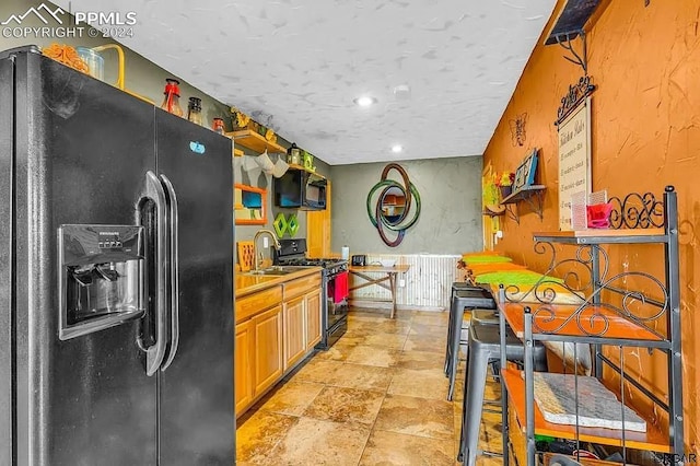 kitchen with black appliances and sink