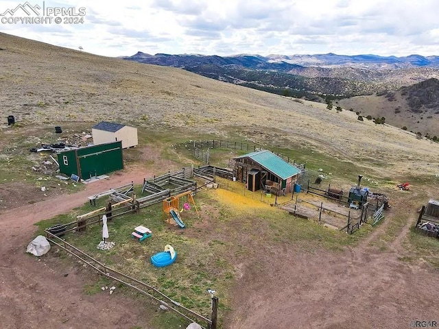 drone / aerial view featuring a mountain view and a rural view