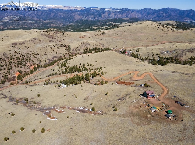 birds eye view of property with a mountain view