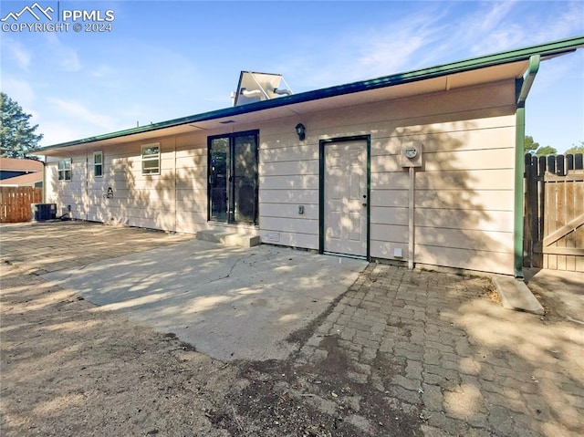 back of property featuring a patio area and central air condition unit