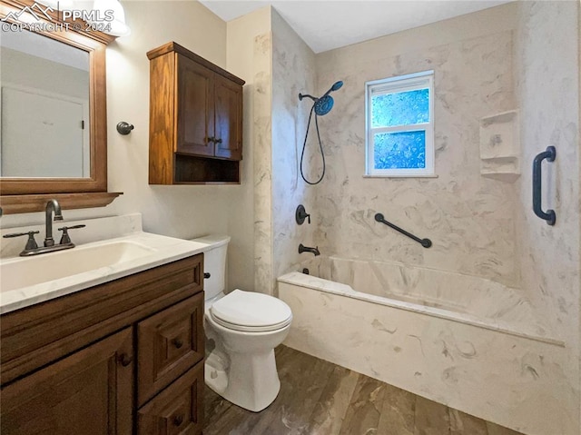 full bathroom featuring tiled shower / bath, vanity, and toilet