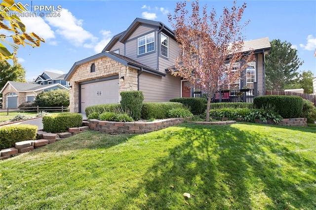 view of front of home with a front yard and a garage