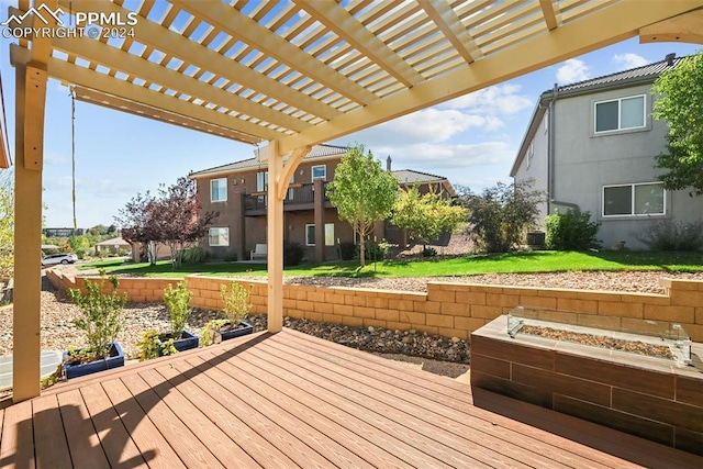 deck featuring a lawn and a pergola