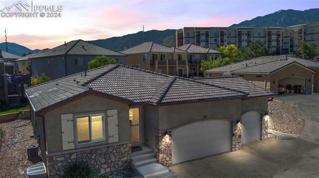 view of front facade with a garage and a mountain view