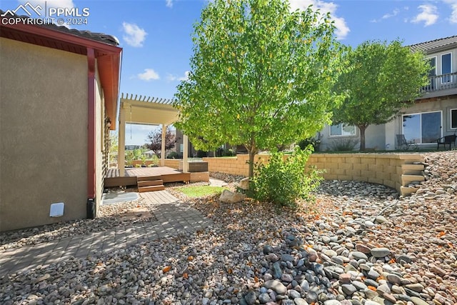 view of yard featuring a wooden deck