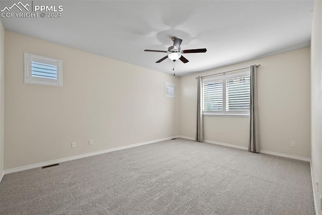 carpeted empty room featuring ceiling fan