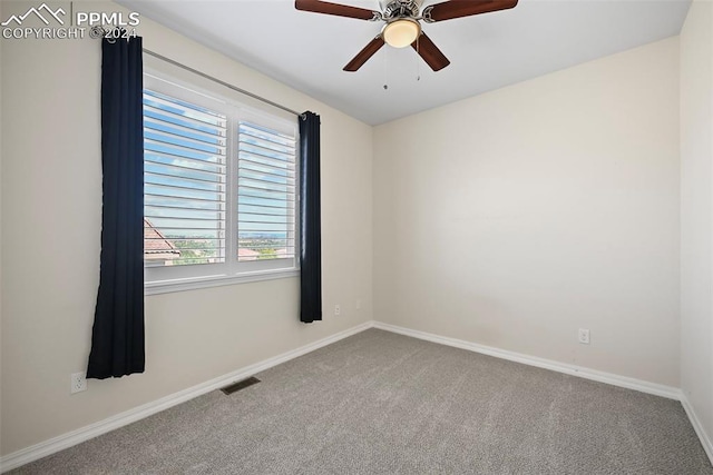 spare room with carpet floors and ceiling fan