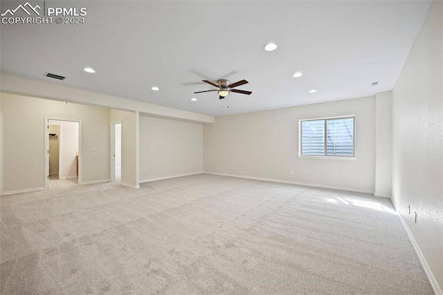 unfurnished room featuring ceiling fan and light colored carpet