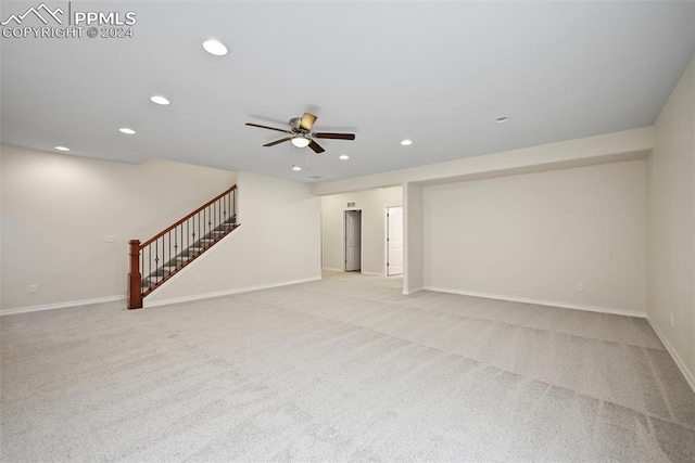 unfurnished living room with light carpet and ceiling fan