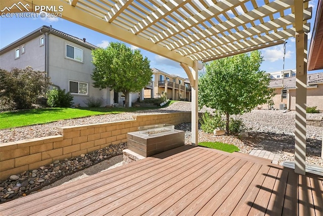 deck featuring a lawn and a pergola