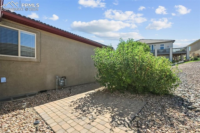 view of side of property with a patio