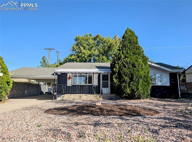 view of front of house with covered porch and a carport